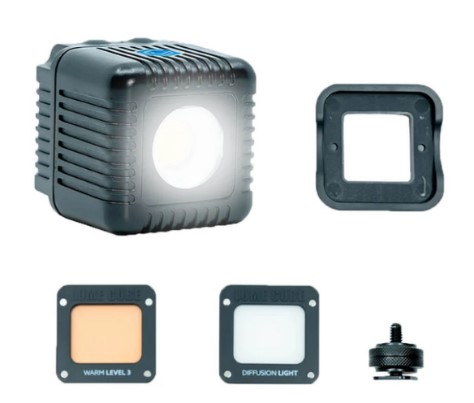 Small black LED light with warm diffuser, soft diffuser click on panels plus cold shoe mount.